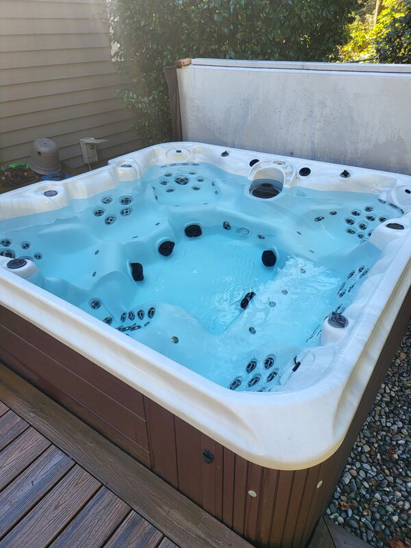 Vivid blue water in a river-rock backyard in the sun